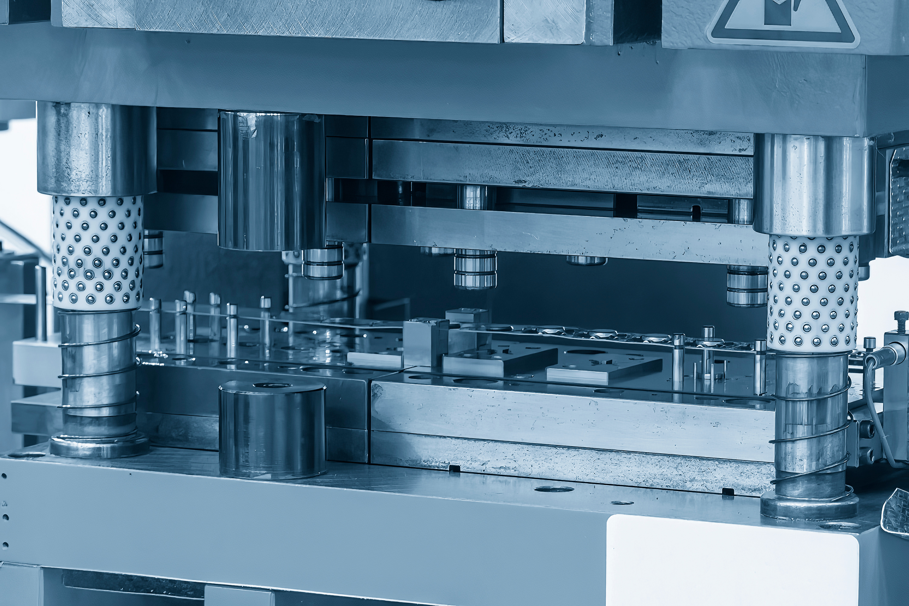 Closeup scene of the progressive die operation in the light blue scene.